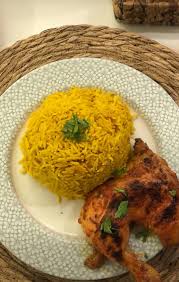 Half a grilled chicken with rice
